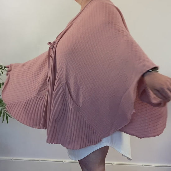 Jo turns in a circle to show off the fullness of the pink cardi-cape with front ribbing and those handy pockets. Designed for best hot flash relief