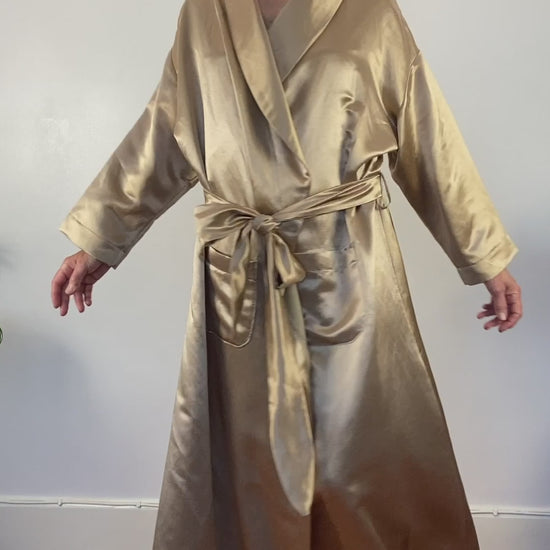 A video showing a woman twirling and smiling at camera in floor length wrap - designed to stop to waking up hot and sweaty